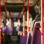 Person sat on a bus, photo taken from inside the bus