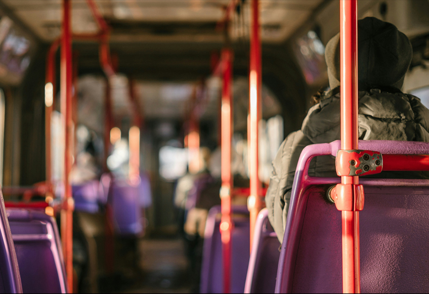 Person sat on a bus, photo taken from inside the bus